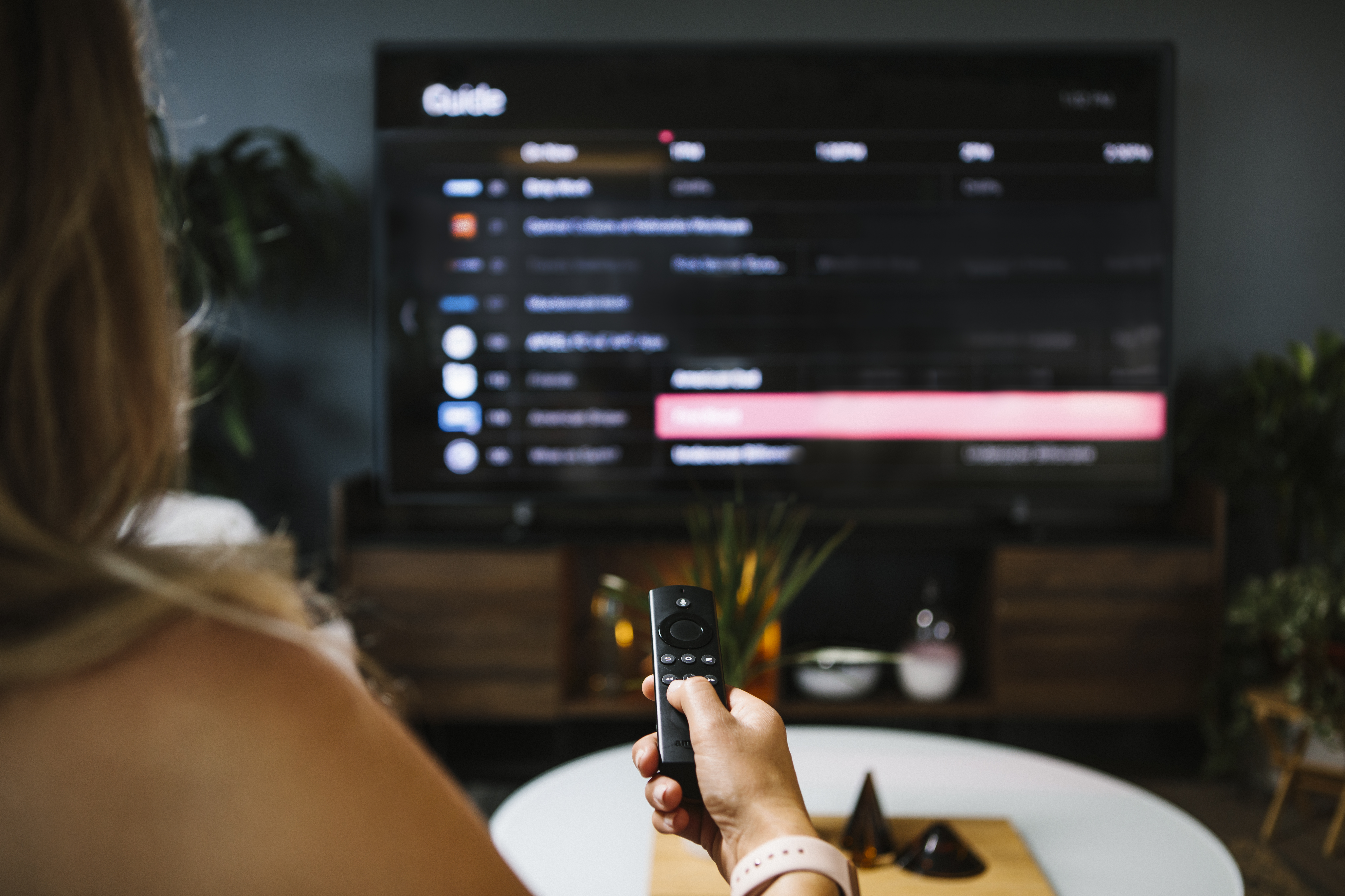 woman viewing the guide using an Amazon Fire TV